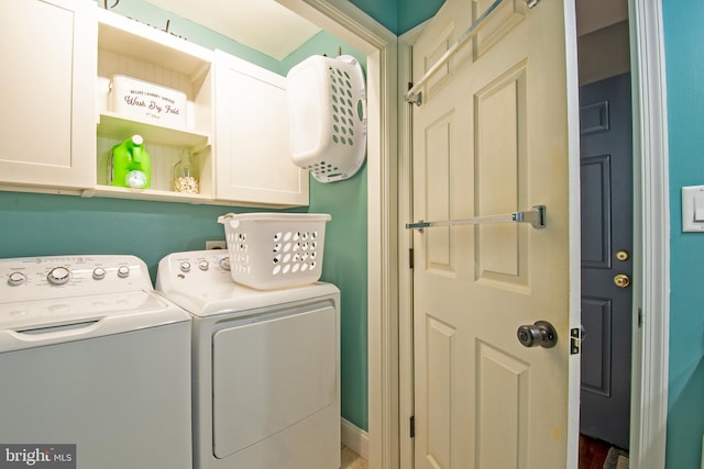 washroom featuring washer and dryer and cabinet space