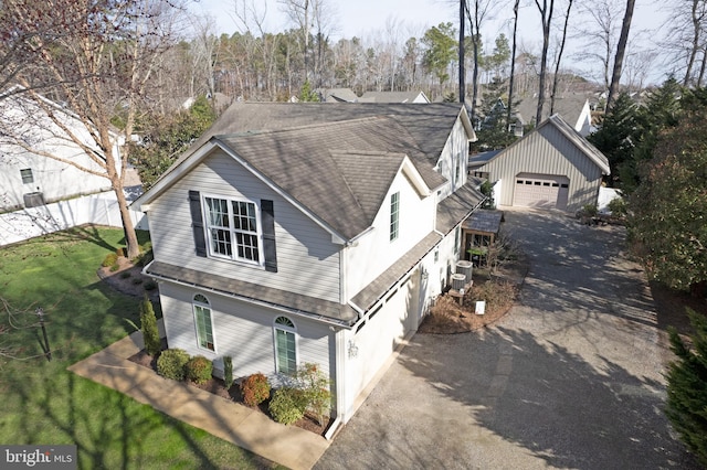 view of front of house with cooling unit and a front lawn