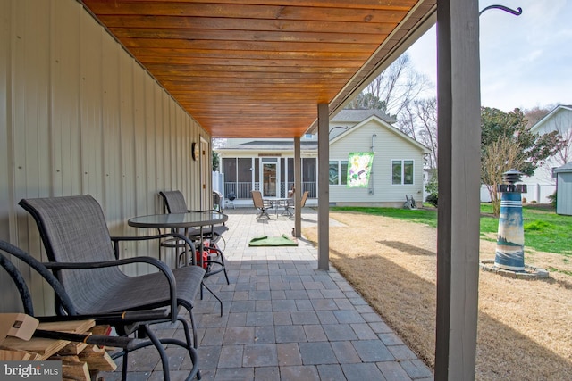 view of patio featuring a sunroom