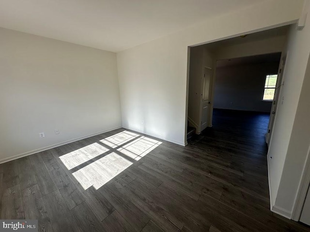 unfurnished room with dark hardwood / wood-style floors