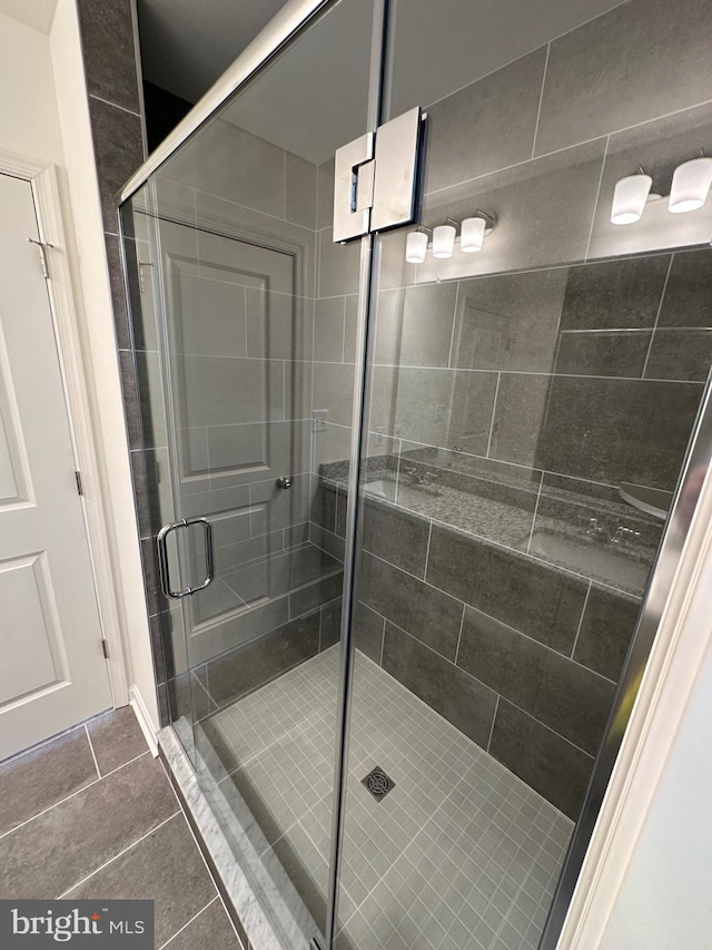 bathroom with walk in shower and tile patterned floors