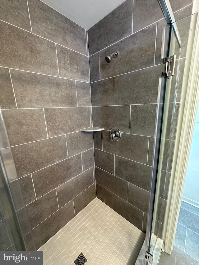 bathroom with tiled shower