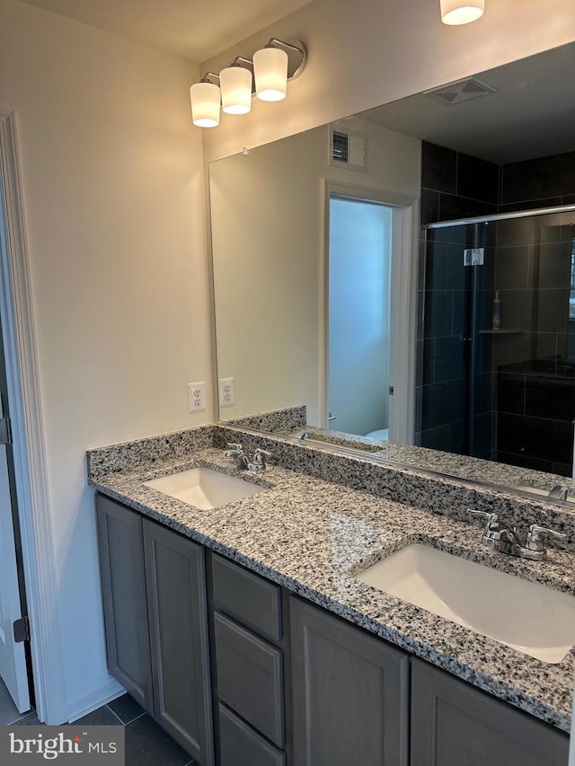 bathroom with walk in shower, tile patterned floors, and vanity