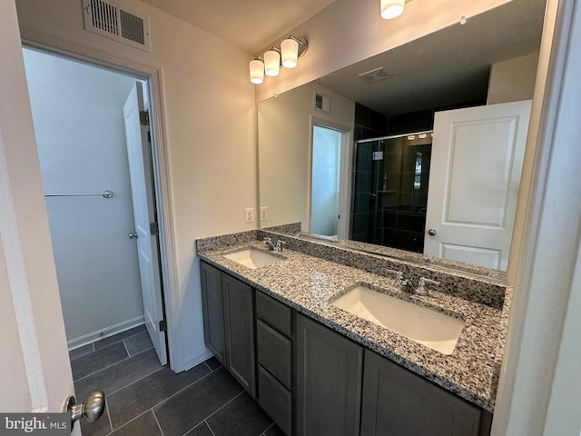 bathroom with tile patterned floors, vanity, and a shower with shower door