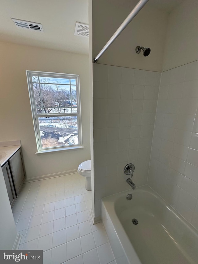 full bathroom featuring vanity, toilet, tiled shower / bath combo, and tile patterned flooring