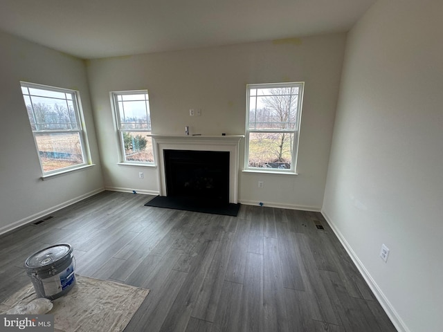 unfurnished living room with dark wood-type flooring