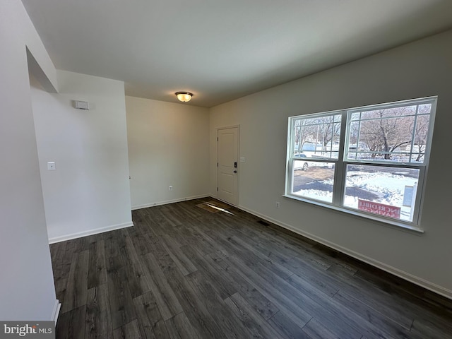 empty room with dark hardwood / wood-style floors