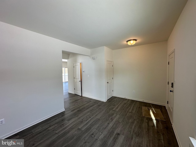 empty room with dark hardwood / wood-style floors