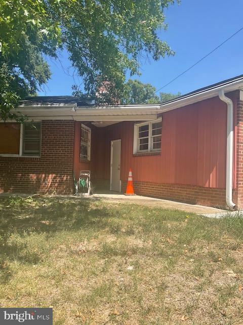 rear view of property with a lawn