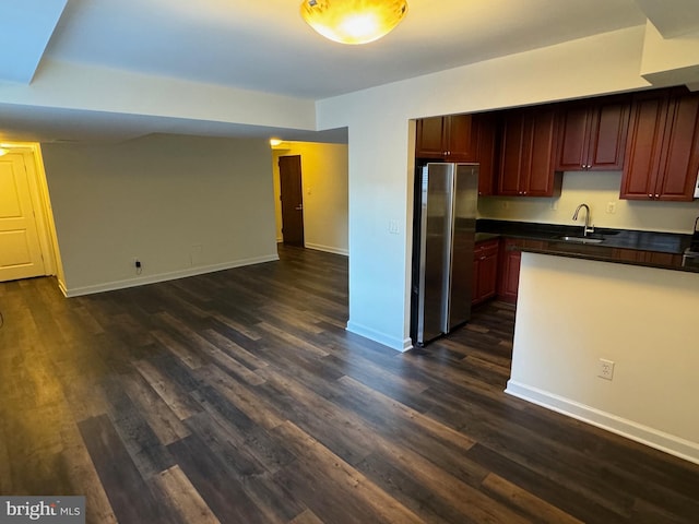 kitchen with stainless steel refrigerator, sink, and dark hardwood / wood-style floors