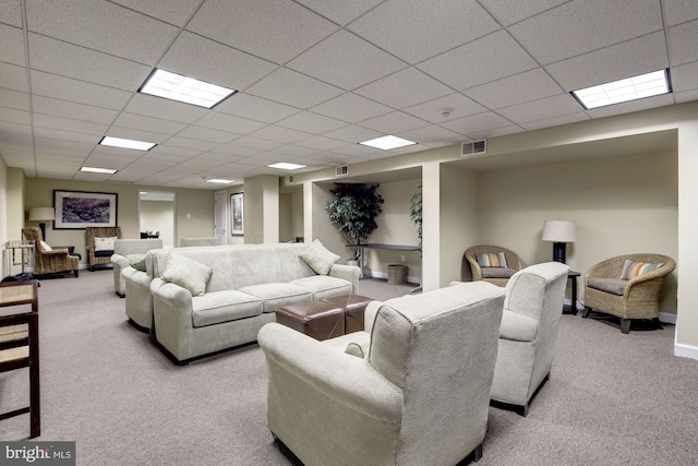 carpeted living room featuring a paneled ceiling