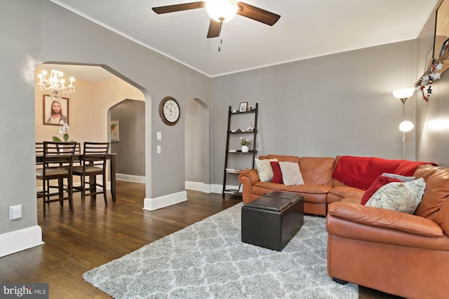 living room featuring ceiling fan with notable chandelier, crown molding, and dark hardwood / wood-style floors