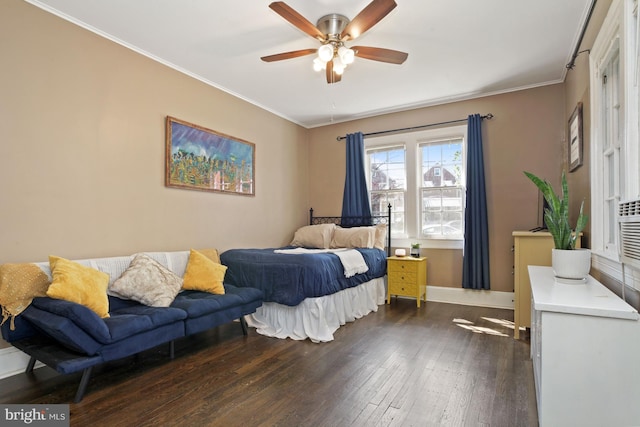 bedroom featuring ceiling fan, dark hardwood / wood-style flooring, and ornamental molding