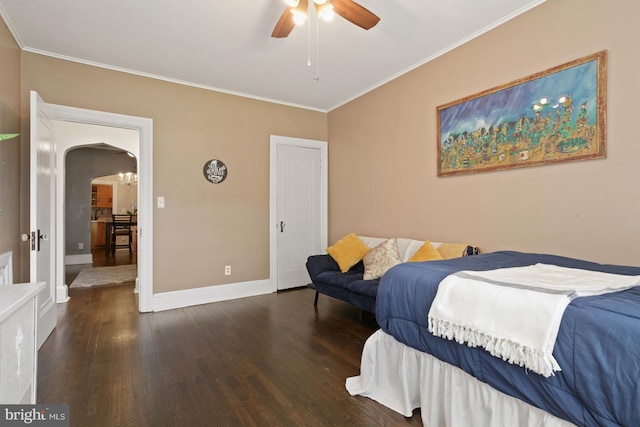 bedroom featuring dark wood-type flooring, ceiling fan, and crown molding