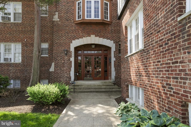 property entrance featuring cooling unit and french doors