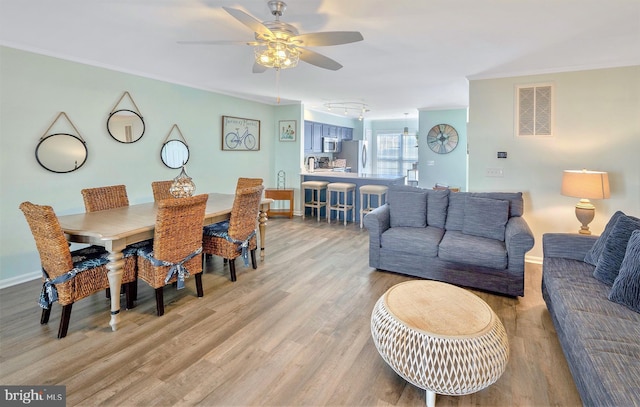 dining room featuring crown molding, ceiling fan, and hardwood / wood-style floors