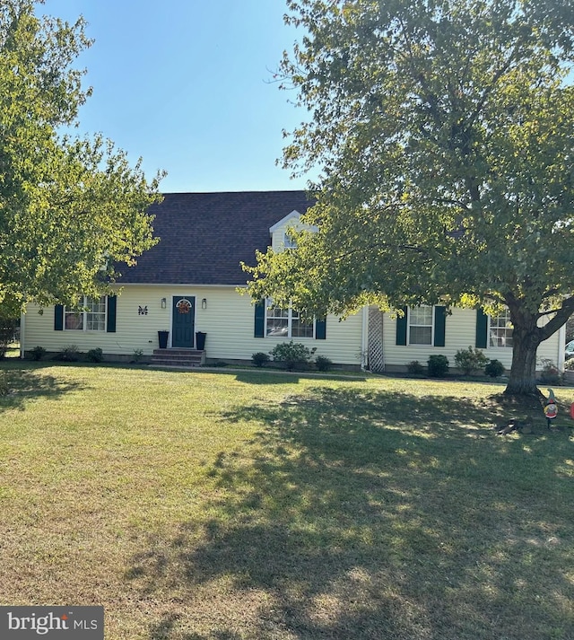 new england style home with a front lawn and a shingled roof