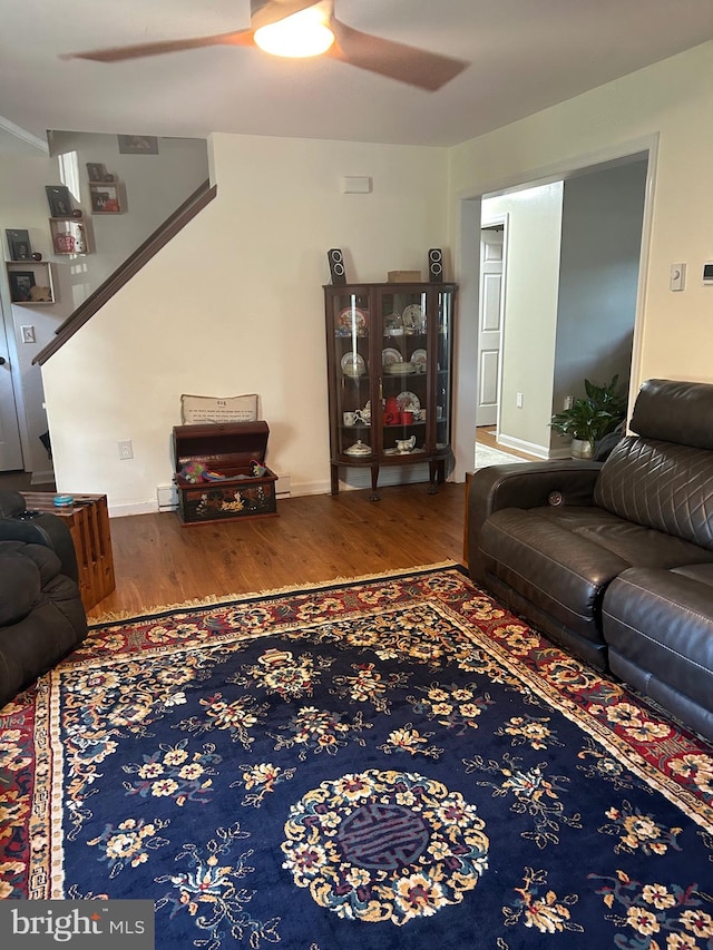 living room featuring ceiling fan and hardwood / wood-style floors