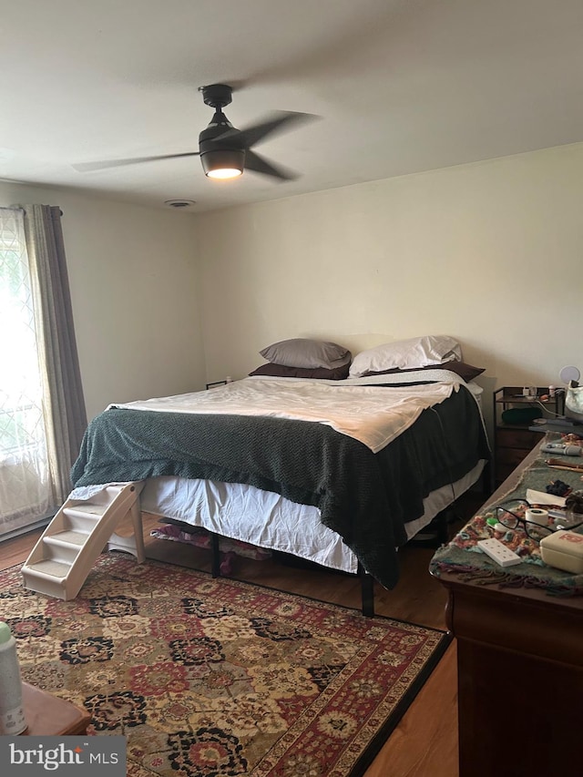 bedroom featuring hardwood / wood-style floors and ceiling fan