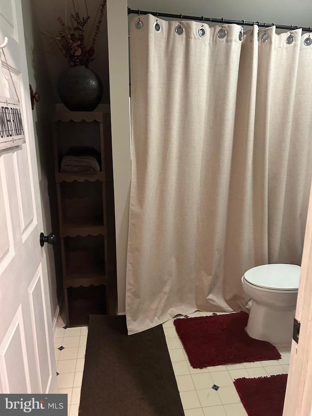 full bath featuring toilet and tile patterned floors