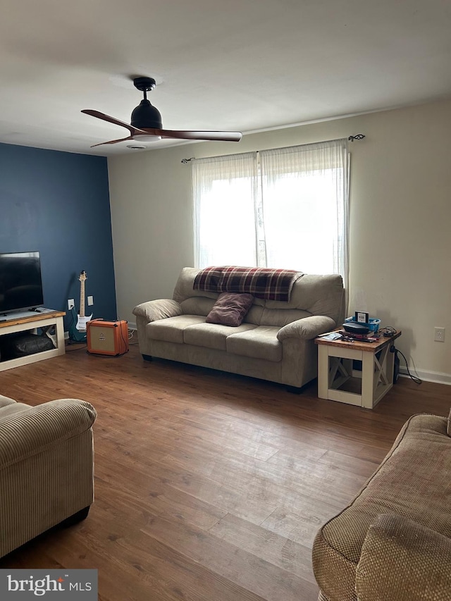 living room featuring ceiling fan and wood finished floors