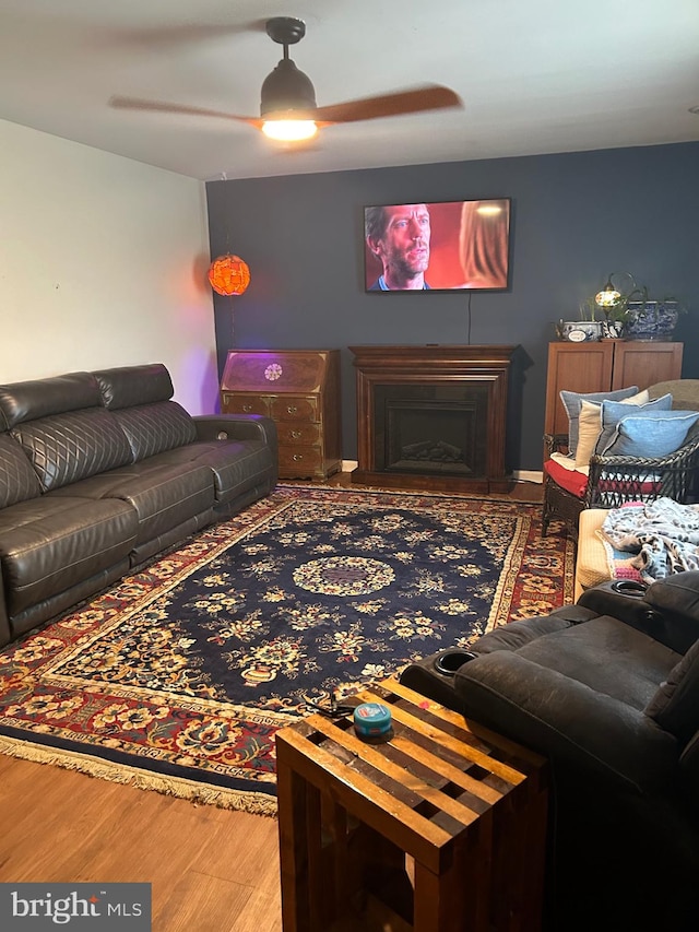 living room featuring ceiling fan and hardwood / wood-style floors