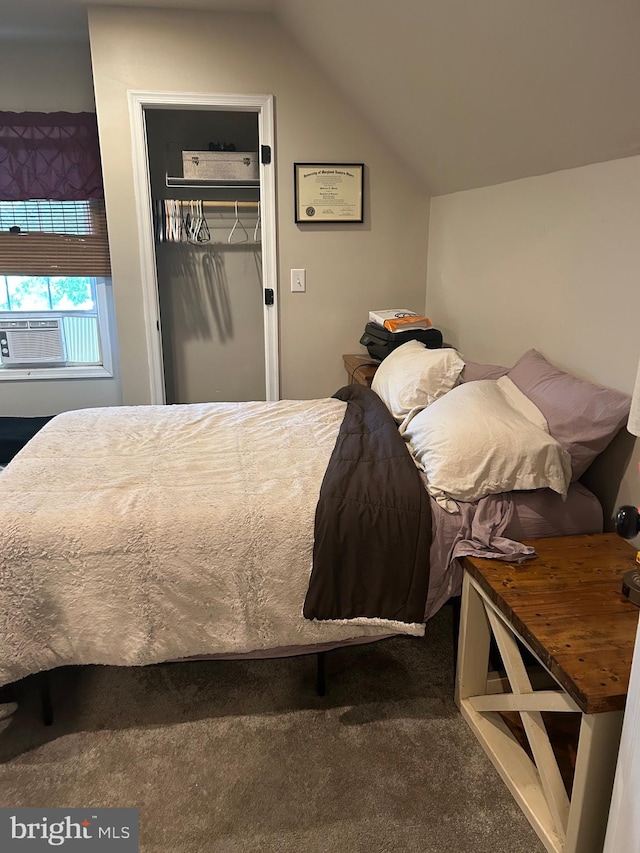 carpeted bedroom with cooling unit, lofted ceiling, a walk in closet, and a closet