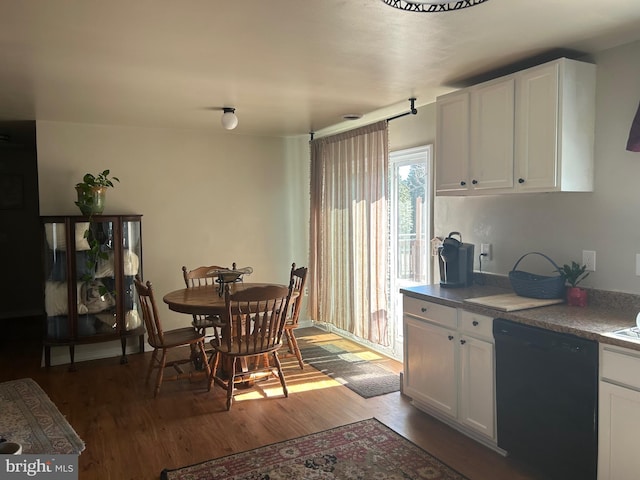 kitchen featuring black dishwasher, white cabinets, and wood finished floors