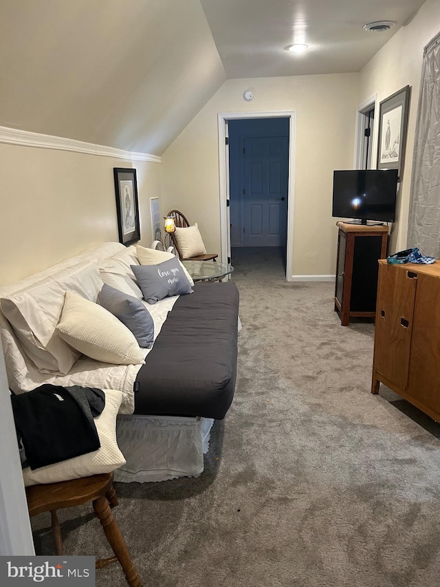 carpeted bedroom featuring crown molding and lofted ceiling