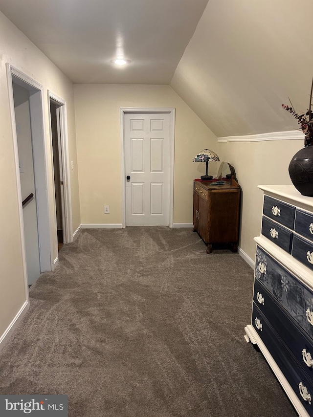 carpeted bedroom featuring baseboards and vaulted ceiling