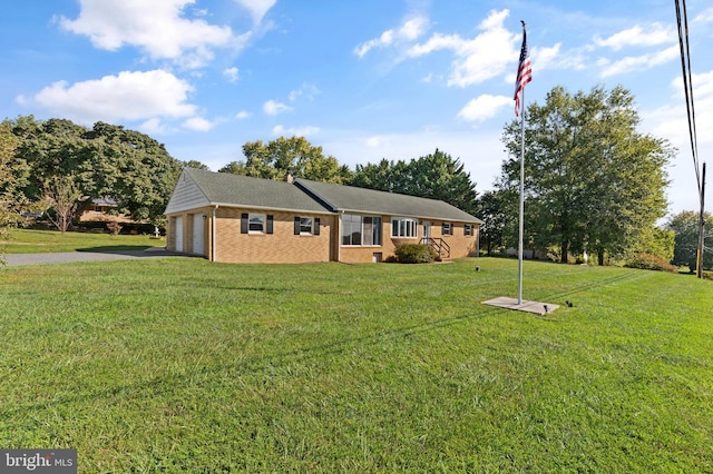 view of front of house with a garage and a front yard