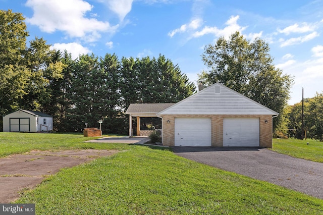 view of front of house featuring a front yard, a shed, and a garage