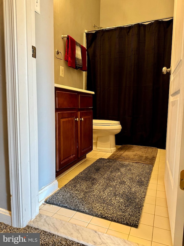 bathroom with toilet and tile patterned floors