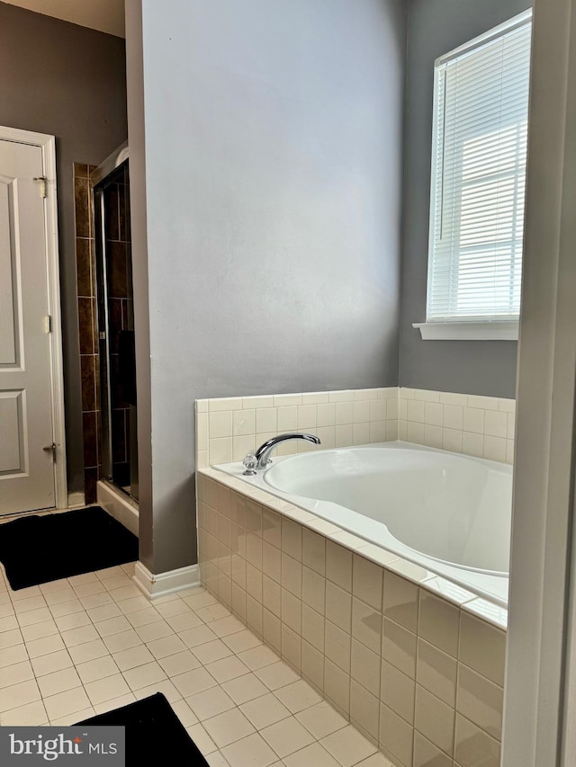 bathroom featuring plus walk in shower and tile patterned floors