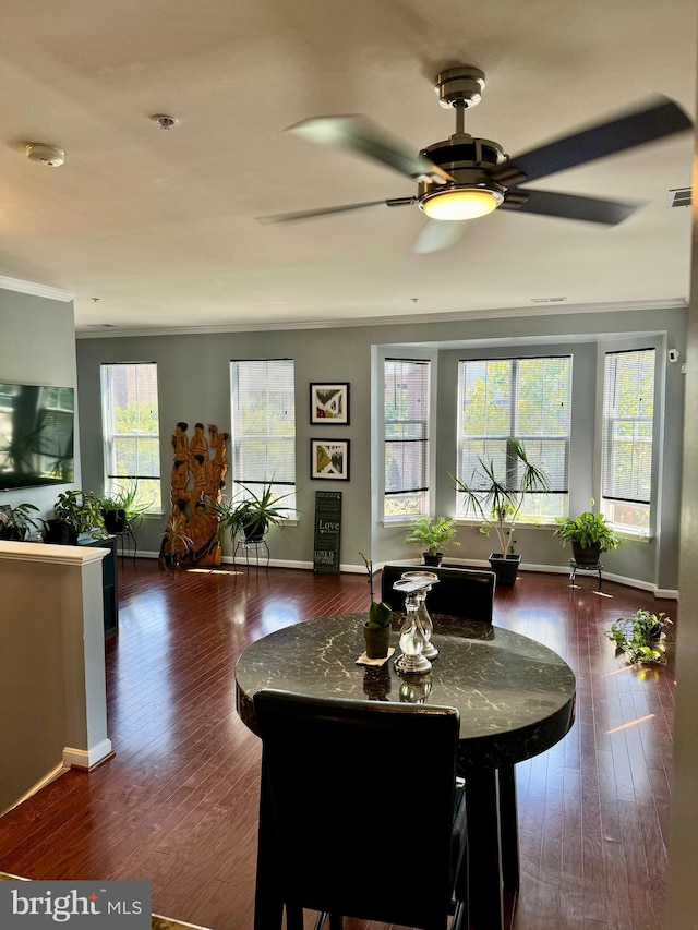 dining area featuring crown molding, ceiling fan, and dark hardwood / wood-style floors