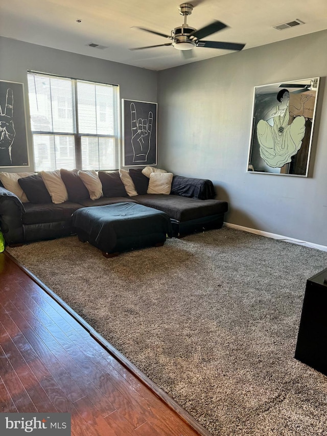 living room featuring hardwood / wood-style flooring and ceiling fan