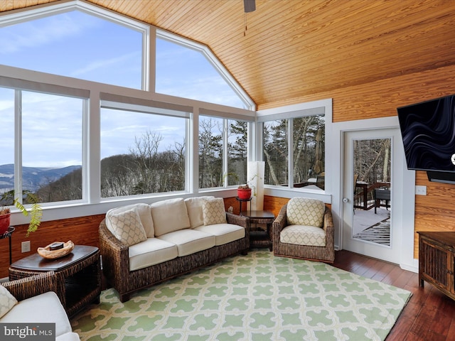 sunroom / solarium with a mountain view, wood ceiling, and vaulted ceiling