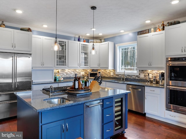 kitchen featuring white cabinetry, a center island with sink, and appliances with stainless steel finishes