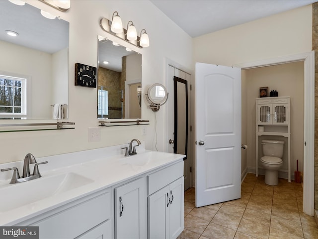 bathroom with vanity, toilet, and tile patterned flooring