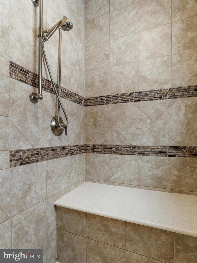 bathroom with a tile shower