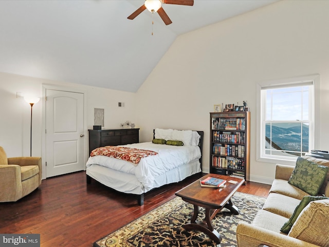 bedroom featuring dark hardwood / wood-style flooring, vaulted ceiling, and ceiling fan