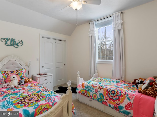 carpeted bedroom featuring lofted ceiling, ceiling fan, and a closet