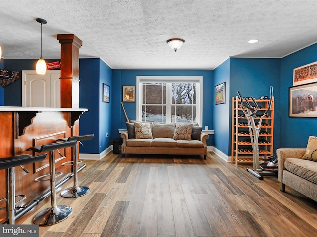 living room featuring hardwood / wood-style flooring and a textured ceiling