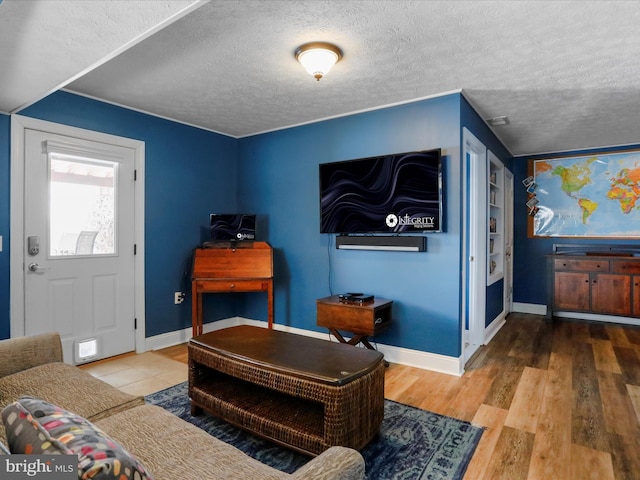 living room with wood-type flooring and a textured ceiling