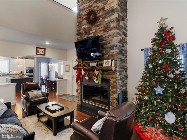 living room with a fireplace, light hardwood / wood-style flooring, and a chandelier