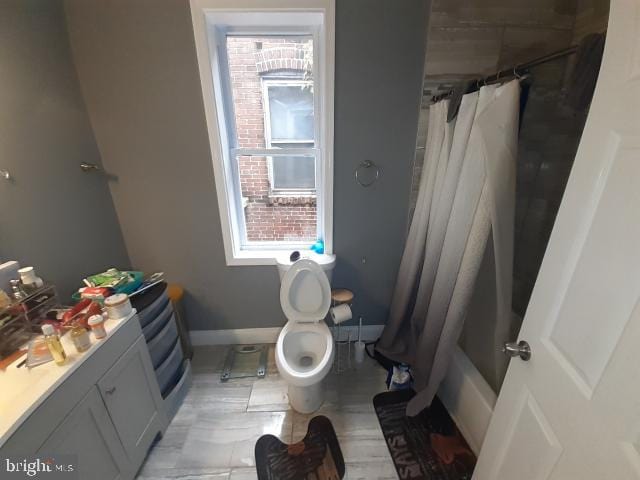 full bathroom featuring vanity, toilet, and shower / bathtub combination with curtain