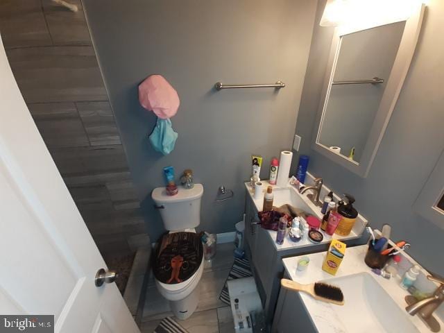 bathroom featuring vanity, toilet, and tile patterned flooring