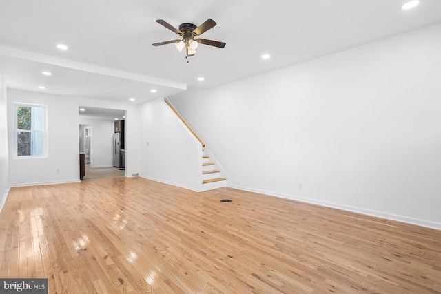 unfurnished living room with ceiling fan and light hardwood / wood-style floors