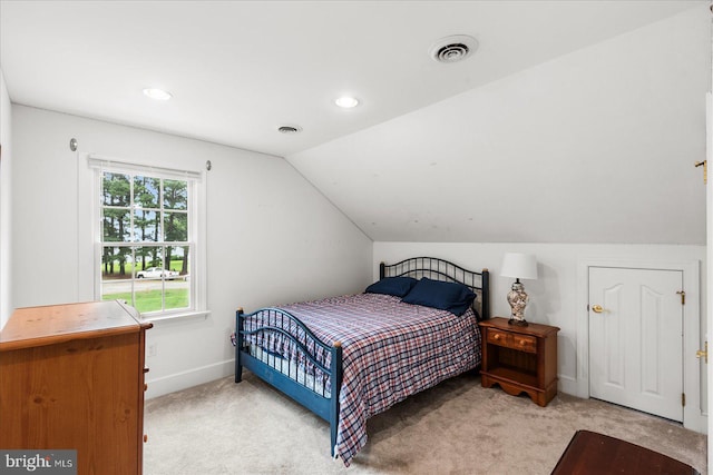 carpeted bedroom with vaulted ceiling