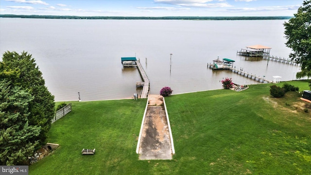 dock area with a water view and a lawn